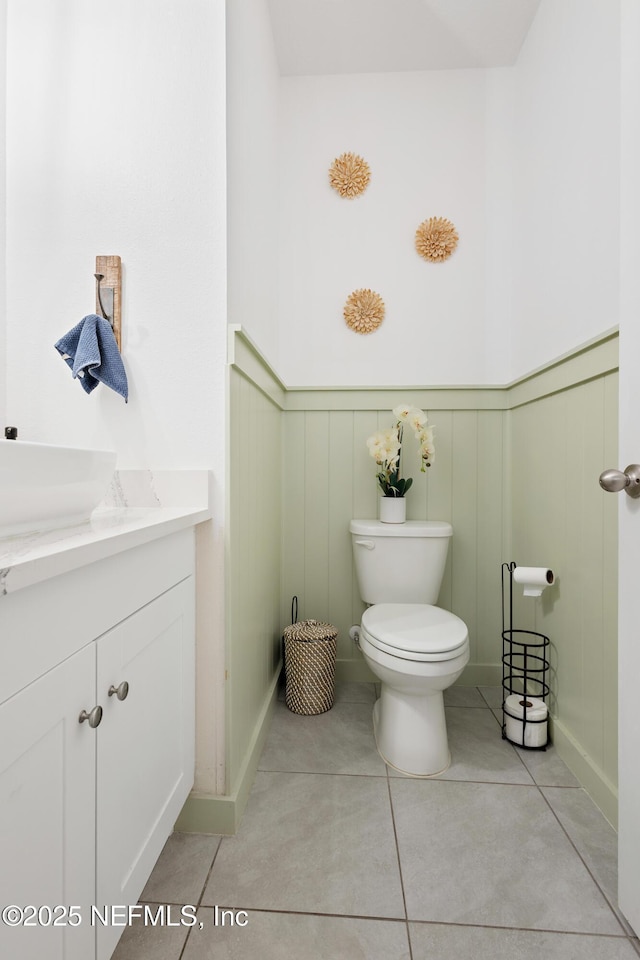 79 Coastline Way, Saint Augustine, FL 32092 - bathroom featuring a wainscoted wall, tile patterned floors, toilet, and vanity