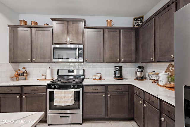 79 Coastline Way, Saint Augustine, FL 32092 - kitchen featuring dark brown cabinets, tasteful backsplash, light countertops, and stainless steel appliances