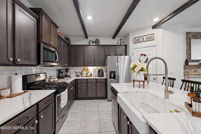79 Coastline Way, Saint Augustine, FL 32092 - kitchen featuring a sink, appliances with stainless steel finishes, beamed ceiling, decorative backsplash, and dark brown cabinets