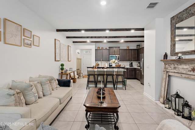 79 Coastline Way, Saint Augustine, FL 32092 - living area with visible vents, light tile patterned floors, and beam ceiling