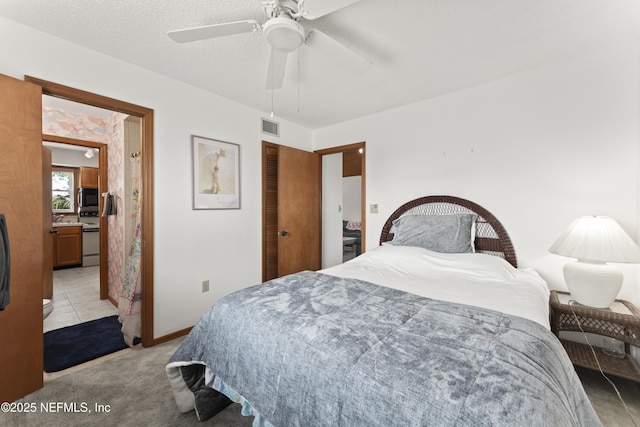 27 Flagler Dr, Palm Coast, FL 32137 - bedroom with a ceiling fan, baseboards, visible vents, a textured ceiling, and light colored carpet