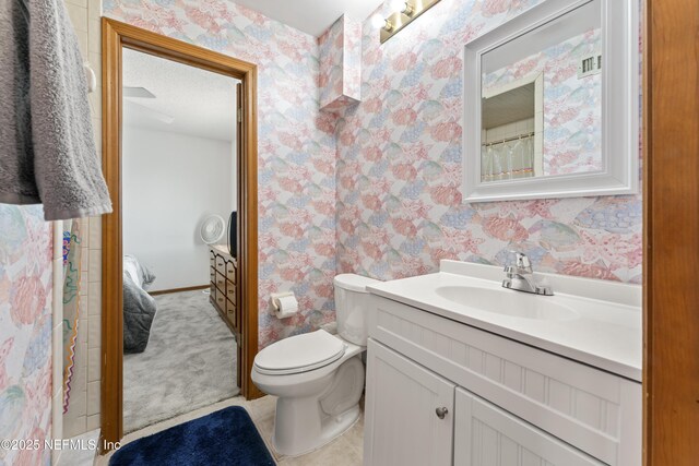 27 Flagler Dr, Palm Coast, FL 32137 - bathroom featuring wallpapered walls, toilet, and vanity