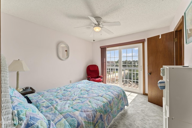27 Flagler Dr, Palm Coast, FL 32137 - bedroom with ceiling fan, light colored carpet, access to exterior, and a textured ceiling