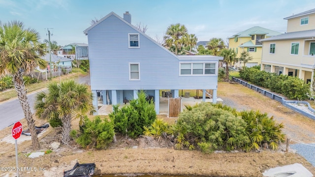 27 Flagler Dr, Palm Coast, FL 32137 - back of property featuring a chimney