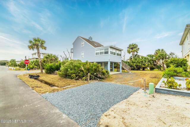 27 Flagler Dr, Palm Coast, FL 32137 - exterior space featuring a chimney and stairs