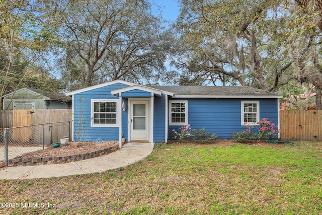 4245 New Hampshire Rd, Elkton, FL 32033 - single story home featuring a gate, fence, and a front lawn