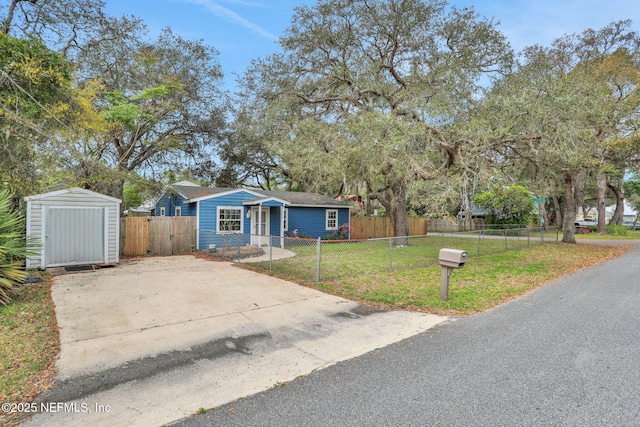 4245 New Hampshire Rd, Elkton, FL 32033 - view of front of home featuring a front lawn, a fenced front yard, a storage unit, and an outbuilding