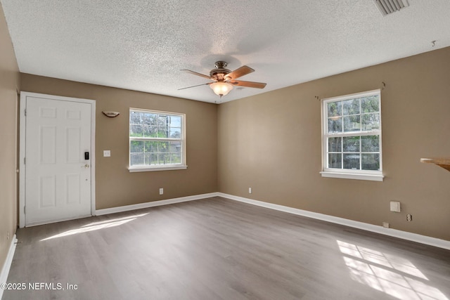 4245 New Hampshire Rd, Elkton, FL 32033 - unfurnished room with baseboards, ceiling fan, and wood finished floors