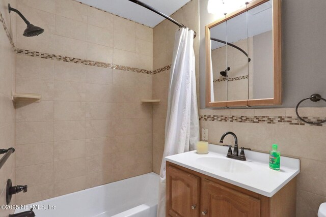 4245 New Hampshire Rd, Elkton, FL 32033 - bathroom featuring tile walls, shower / tub combo with curtain, and vanity
