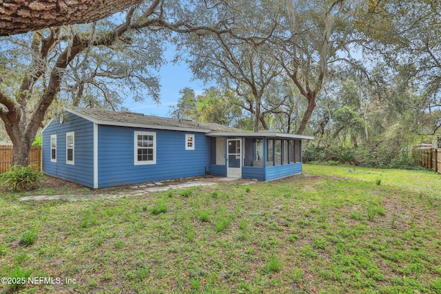 4245 New Hampshire Rd, Elkton, FL 32033 - view of front of property featuring a front lawn, a fenced backyard, and a sunroom