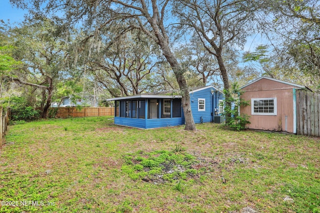 4245 New Hampshire Rd, Elkton, FL 32033 - view of yard with a sunroom, a fenced backyard, and an outdoor structure