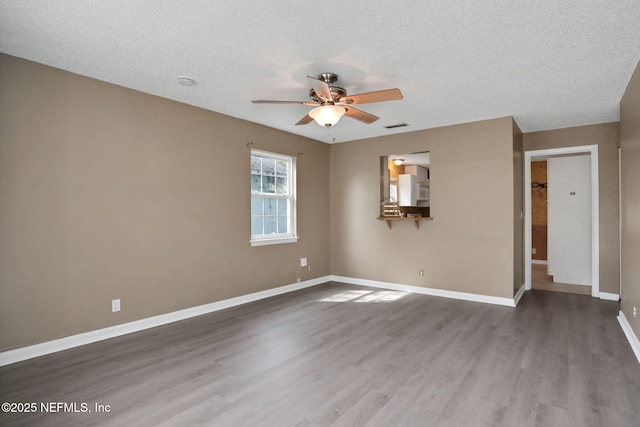 4245 New Hampshire Rd, Elkton, FL 32033 - empty room with visible vents, baseboards, ceiling fan, and wood finished floors