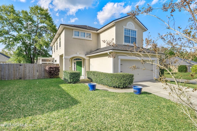traditional-style house with driveway, fence, an attached garage, a front yard, and stucco siding