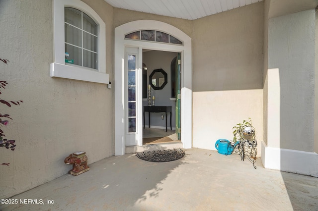property entrance featuring stucco siding