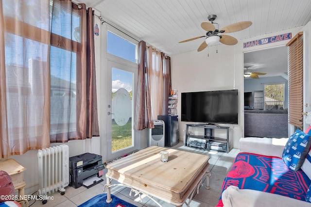 living area with wood ceiling, radiator, and ceiling fan