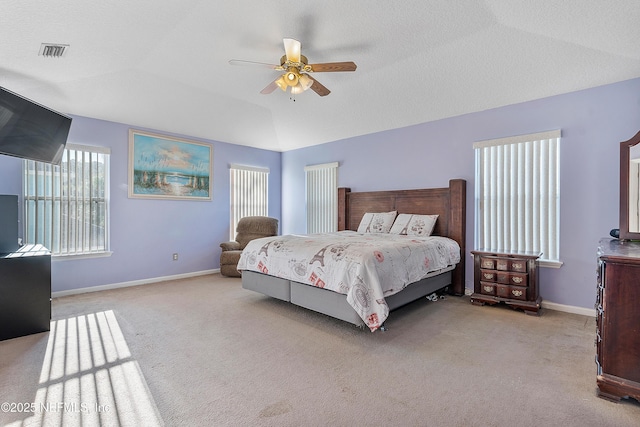 bedroom featuring lofted ceiling, baseboards, visible vents, ceiling fan, and carpet