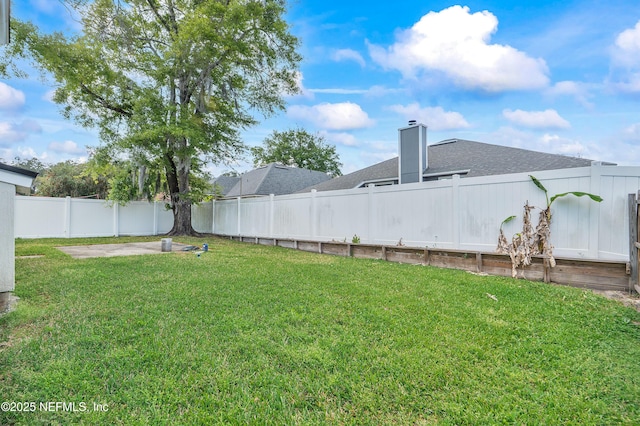 view of yard with a fenced backyard