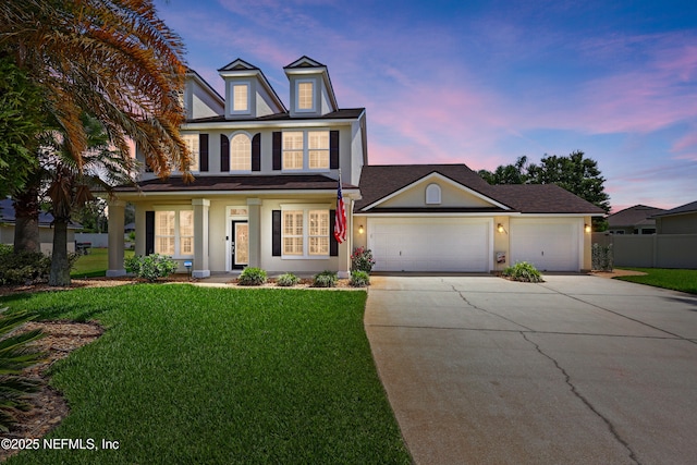 traditional home with concrete driveway, a garage, and stucco siding
