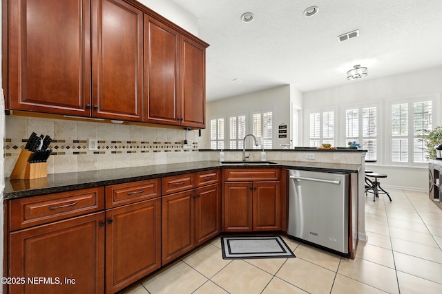 kitchen with dishwasher, a sink, decorative backsplash, light tile patterned floors, and recessed lighting