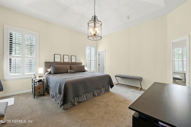 bedroom with a chandelier, carpet, and baseboards