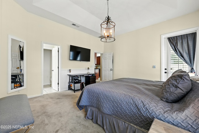 carpeted bedroom with a chandelier and baseboards