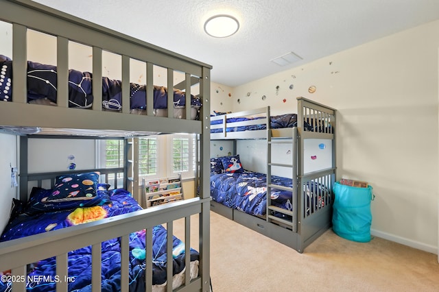 carpeted bedroom featuring a textured ceiling