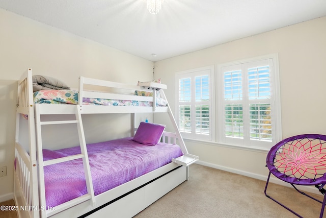 bedroom with baseboards and carpet floors