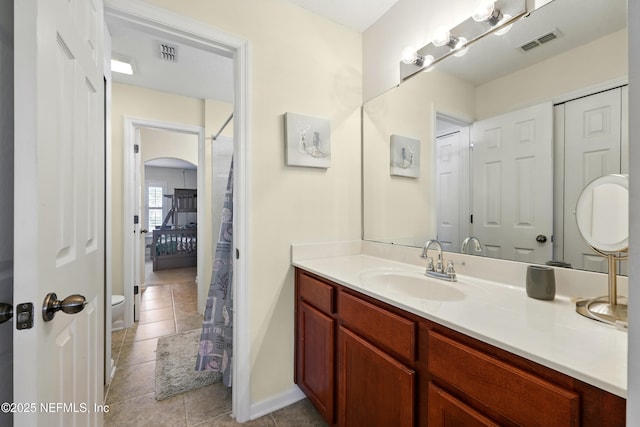 full bathroom with tile patterned floors, vanity, baseboards, and toilet