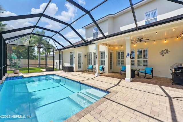 view of swimming pool with a patio, a ceiling fan, area for grilling, and a lanai