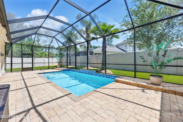 view of pool with a patio, a fenced backyard, and a lanai