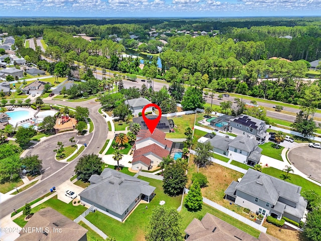aerial view of residential area with a heavily wooded area