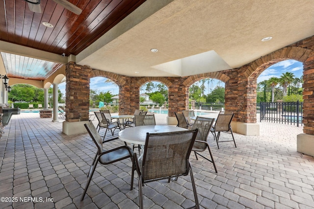 view of patio featuring an outdoor pool, a ceiling fan, and outdoor dining area