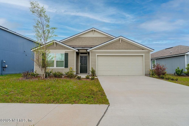 view of front of home with a front lawn, driveway, and an attached garage