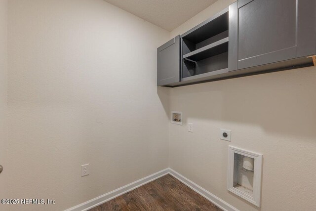 washroom featuring washer hookup, hookup for an electric dryer, baseboards, cabinet space, and dark wood-style flooring