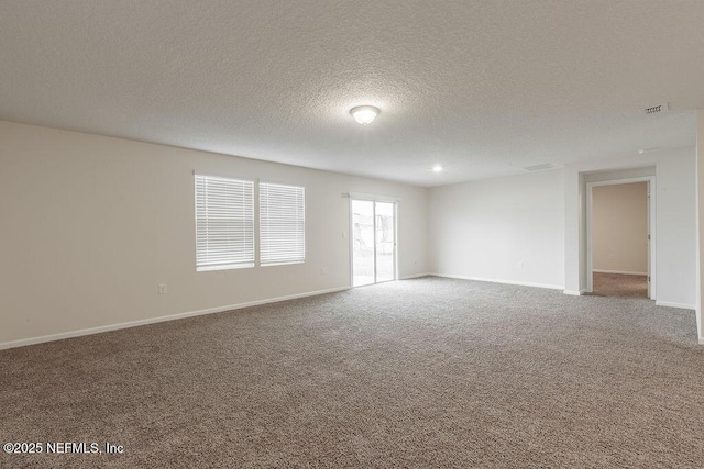 unfurnished room featuring baseboards, visible vents, carpet flooring, and a textured ceiling