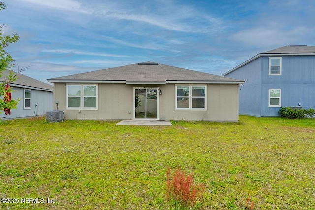rear view of property featuring cooling unit, a patio, and a lawn