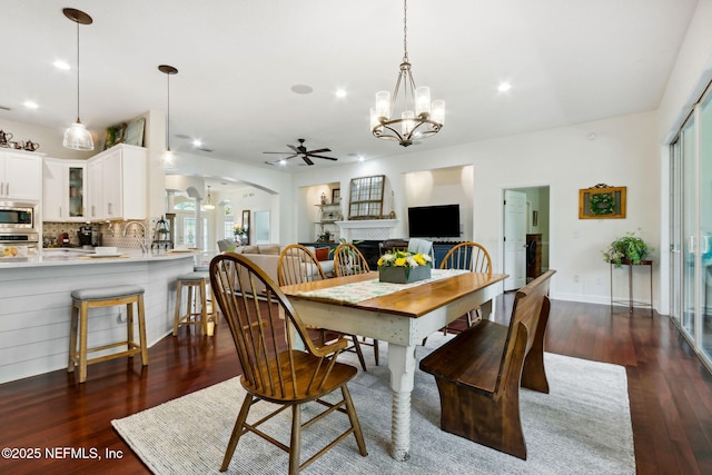 95150 Starling Ct, Fernandina Beach, FL 32034 - dining area featuring ceiling fan, arched walkways, dark wood-type flooring, recessed lighting, and a chandelier