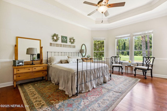 95150 Starling Ct, Fernandina Beach, FL 32034 - bedroom with a tray ceiling, wood finished floors, baseboards, crown molding, and ceiling fan