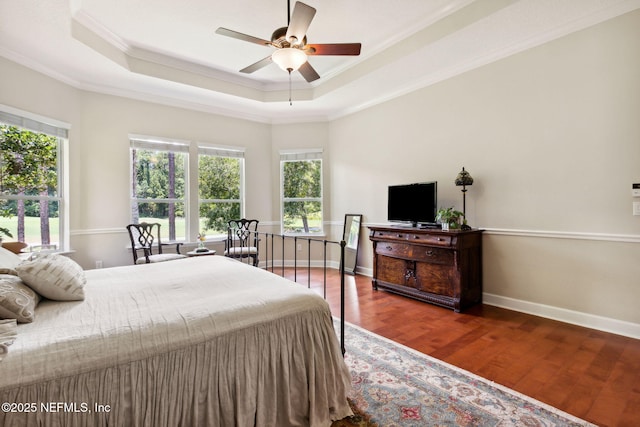 95150 Starling Ct, Fernandina Beach, FL 32034 - bedroom with multiple windows, ornamental molding, wood finished floors, a tray ceiling, and baseboards