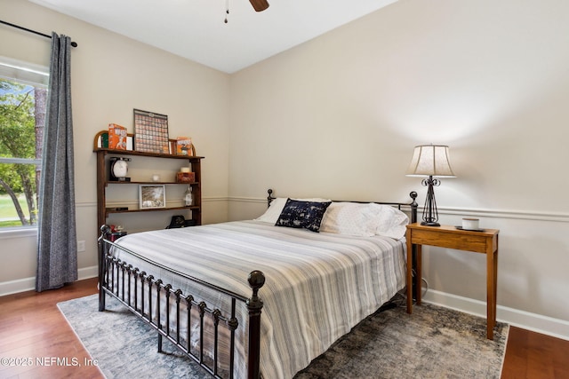 95150 Starling Ct, Fernandina Beach, FL 32034 - bedroom featuring multiple windows, wood finished floors, baseboards, and a ceiling fan