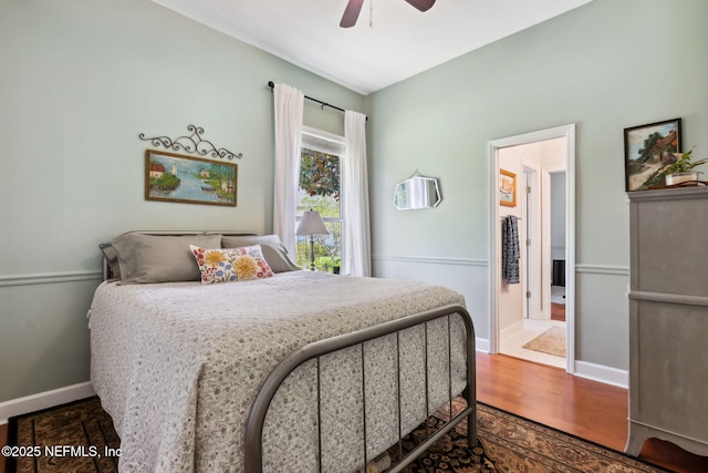 95150 Starling Ct, Fernandina Beach, FL 32034 - bedroom featuring baseboards, wood finished floors, a ceiling fan, and ensuite bathroom