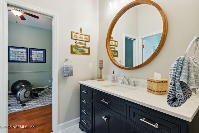 95150 Starling Ct, Fernandina Beach, FL 32034 - bathroom with vanity, a ceiling fan, wood finished floors, and baseboards