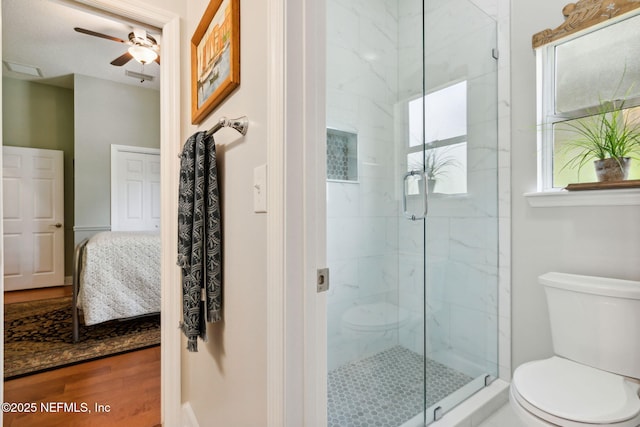 95150 Starling Ct, Fernandina Beach, FL 32034 - ensuite bathroom with toilet, ceiling fan, a marble finish shower, and wood finished floors