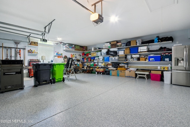 95150 Starling Ct, Fernandina Beach, FL 32034 - garage featuring stainless steel refrigerator with ice dispenser and a garage door opener