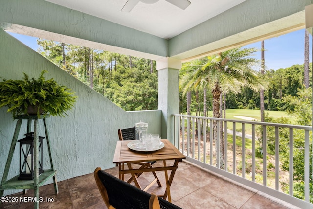 95150 Starling Ct, Fernandina Beach, FL 32034 - balcony featuring a ceiling fan, view of wooded area, and view of golf course