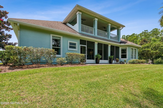 95150 Starling Ct, Fernandina Beach, FL 32034 - back of house featuring a balcony, a shingled roof, a ceiling fan, a yard, and a sunroom