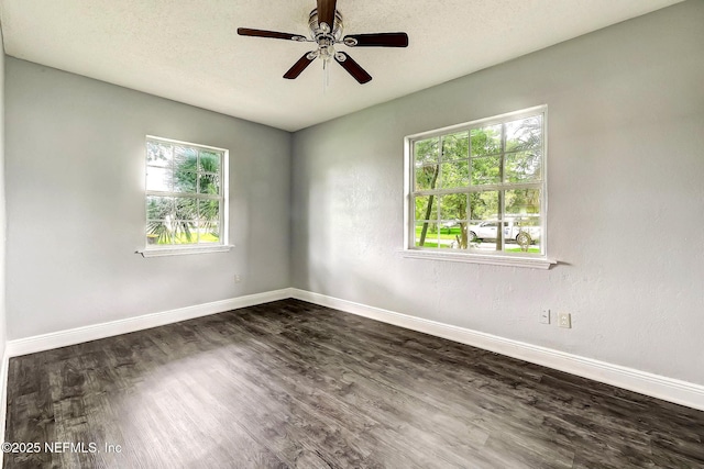 979 Mikael Ave, Jacksonville, FL 32205 - unfurnished room featuring plenty of natural light, dark wood-type flooring, baseboards, and a textured ceiling