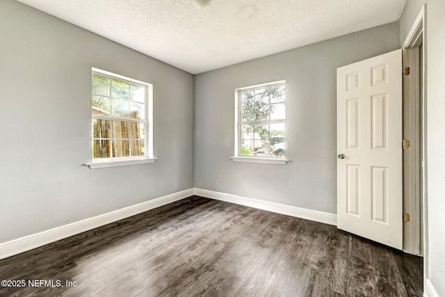 979 Mikael Ave, Jacksonville, FL 32205 - spare room with dark wood-type flooring, baseboards, and a textured ceiling