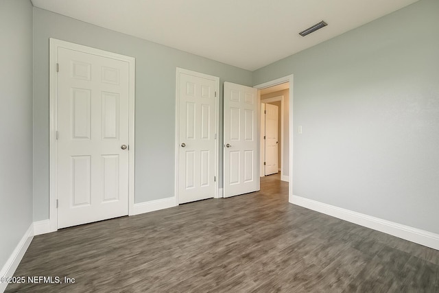 979 Mikael Ave, Jacksonville, FL 32205 - unfurnished bedroom with wood finished floors and baseboards