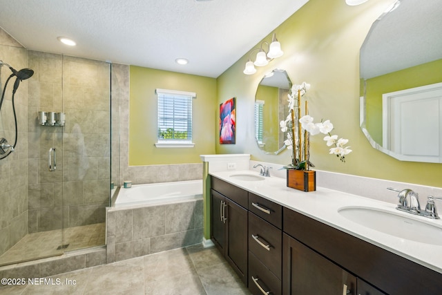 full bath featuring a bath, a sink, tile patterned flooring, and a shower stall
